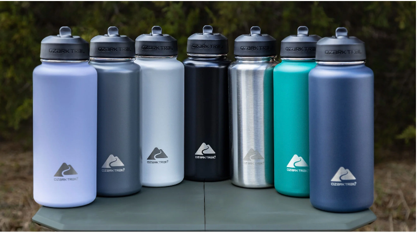 Seven 32 ounce Ozark Trail insulated stainless steel water bottles in a row.