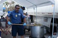 Worker giving away food at a Mobile Relief Kitchen